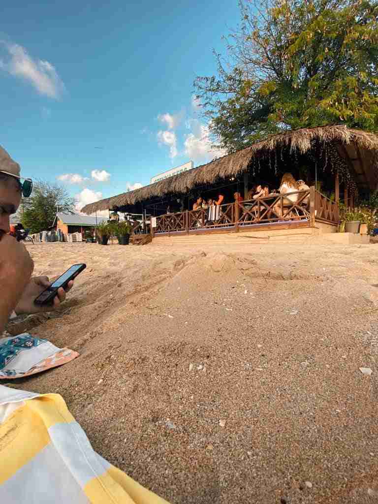 beach bar at sunset on reduit bay in st lucia