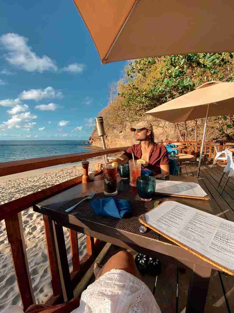 man looking at sunset view from naked fisherman smugglers cove st lucia