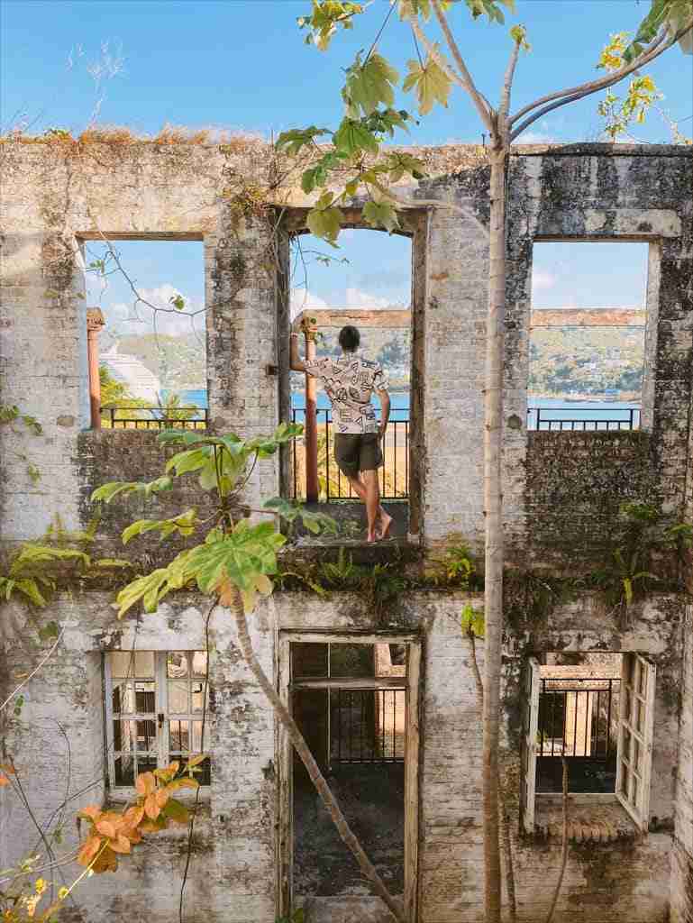 a photo of a man at meadows battery ruins, one of the things to do in castries st lucia