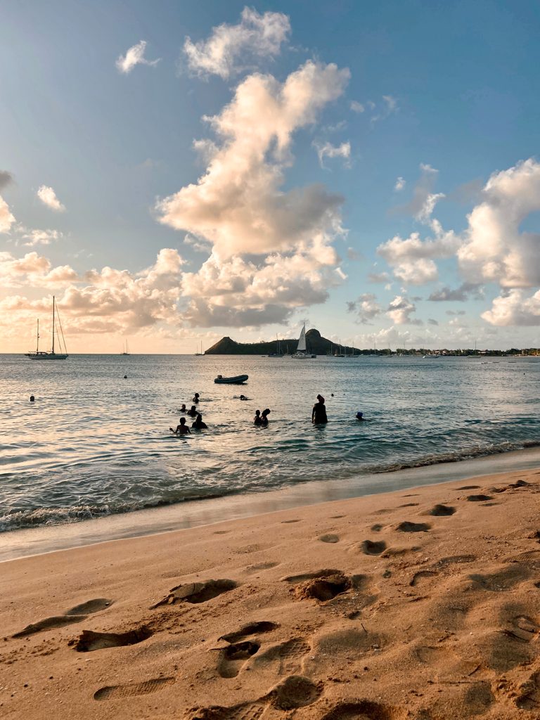 a group of people in the water at reduit beach in st lucia